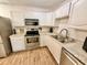 Kitchen featuring white cabinetry, stainless steel appliances, and hardwood flooring at 6800 E Tennessee Ave # 351, Denver, CO 80224