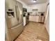 A well-lit kitchen featuring stainless steel appliances, white cabinetry, and hardwood flooring at 6800 E Tennessee Ave # 351, Denver, CO 80224