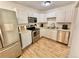 Spacious kitchen with white cabinets, stainless steel appliances, and durable hardwood floors at 6800 E Tennessee Ave # 351, Denver, CO 80224