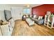 Inviting living room features a comfortable sectional sofa, red brick accent wall, and bright natural light at 6800 E Tennessee Ave # 351, Denver, CO 80224