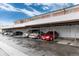 Covered parking area with assigned spaces for residents, providing shelter for multiple vehicles at 6800 E Tennessee Ave # 351, Denver, CO 80224