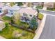 Aerial view of a well-maintained property with a fenced backyard, mature trees, and a charming patio area at 2736 Poplar Grove Pl, Castle Rock, CO 80109