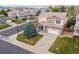 Beautifully landscaped property featuring a well-maintained lawn and a two-car garage at 2736 Poplar Grove Pl, Castle Rock, CO 80109