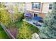 Aerial view showcases a home's backyard with a patio, grill, and well-manicured landscaping at 2736 Poplar Grove Pl, Castle Rock, CO 80109