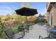 Back patio featuring multiple seating areas, patio umbrellas, and well-maintained landscaping at 2736 Poplar Grove Pl, Castle Rock, CO 80109