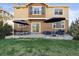 Backyard patio features stylish seating, umbrellas for shade, and a lush green lawn at 2736 Poplar Grove Pl, Castle Rock, CO 80109