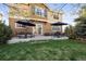 Backyard patio features stylish seating, umbrellas for shade, and a lush green lawn at 2736 Poplar Grove Pl, Castle Rock, CO 80109