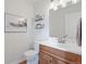 Well-lit powder room featuring a wood vanity and decorative elements at 2736 Poplar Grove Pl, Castle Rock, CO 80109