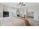 Bedroom with white walls, neutral carpet, ceiling fan, and a view into the bathroom at 2736 Poplar Grove Pl, Castle Rock, CO 80109