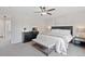 Bright bedroom featuring large bed, upholstered bench, ceiling fan, and neutral decor at 2736 Poplar Grove Pl, Castle Rock, CO 80109