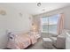 Cozy bedroom with a single bed and a sitting area next to a bright window at 2736 Poplar Grove Pl, Castle Rock, CO 80109