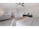 View of bedroom with ceiling fan, white walls, neutral carpet, and a view into the bathroom at 2736 Poplar Grove Pl, Castle Rock, CO 80109