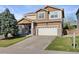 Traditional two-story home with a manicured lawn and a spacious two-car garage at 2736 Poplar Grove Pl, Castle Rock, CO 80109