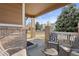 Welcoming front porch with chairs, a small table, and brick accents on the columns at 2736 Poplar Grove Pl, Castle Rock, CO 80109