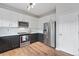 Modern kitchen with stainless steel appliances, white cabinets, and sleek countertops at 2736 Poplar Grove Pl, Castle Rock, CO 80109
