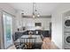 Bright kitchen and dining area featuring modern appliances, stylish lighting, and a sliding glass door at 2736 Poplar Grove Pl, Castle Rock, CO 80109