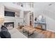Cozy living room featuring a fireplace, hardwood floors, and ample natural light at 2736 Poplar Grove Pl, Castle Rock, CO 80109