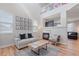 Bright living room with fireplace, wood floors, and an open-concept design at 2736 Poplar Grove Pl, Castle Rock, CO 80109