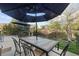 Back patio featuring a table and chairs, and a black patio umbrella at 2736 Poplar Grove Pl, Castle Rock, CO 80109