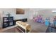 Spacious upper living area with black furniture and doll house for playing at 2736 Poplar Grove Pl, Castle Rock, CO 80109