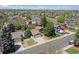 Neighborhood aerial view highlighting the home's setting amongst mature trees and other homes at 8679 Apache Plume Dr, Parker, CO 80134
