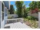 Backyard deck area surrounded by lush greenery and fencing, creating a serene outdoor escape at 8679 Apache Plume Dr, Parker, CO 80134