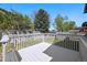 Deck overlooking a fully fenced backyard with mature trees at 8679 Apache Plume Dr, Parker, CO 80134