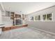 Basement room with bright lighting, fireplace and built-in shelving at 8679 Apache Plume Dr, Parker, CO 80134