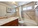 Bathroom features tiled walls, a large mirror, and a shower-tub combination with updated fixtures at 8679 Apache Plume Dr, Parker, CO 80134