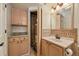 Bathroom with neutral cabinets, sink, and linen closet at 8679 Apache Plume Dr, Parker, CO 80134
