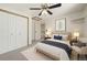 Well-lit bedroom featuring a comfortable bed, ample closet space, and cozy reading chair at 8679 Apache Plume Dr, Parker, CO 80134