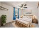 Bedroom with plush bedding, natural lighting from window, and decor, creating a cozy and inviting space at 8679 Apache Plume Dr, Parker, CO 80134