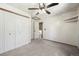 Bedroom featuring plush carpeting, bright lighting, and built-in storage at 8679 Apache Plume Dr, Parker, CO 80134