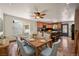 Bright dining area with a wooden table, blue chairs, a ceiling fan and a kitchen view at 8679 Apache Plume Dr, Parker, CO 80134