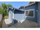 Exterior shot of home features light-blue siding and white trim, with an access door and a small window at 8679 Apache Plume Dr, Parker, CO 80134