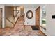 Welcoming foyer with wood-look tile flooring, staircase, and natural wood door at 8679 Apache Plume Dr, Parker, CO 80134