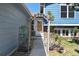 Home's front entrance features a charming wooden trellis and a brick-accented facade at 8679 Apache Plume Dr, Parker, CO 80134