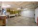 Spacious two car garage with large work bench and shelving at 8679 Apache Plume Dr, Parker, CO 80134