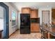 Bright kitchen with stainless steel refrigerator, and wooden cabinets at 8679 Apache Plume Dr, Parker, CO 80134