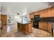 Spacious kitchen featuring an island, modern appliances, tile backsplash, and ample cabinet space at 8679 Apache Plume Dr, Parker, CO 80134