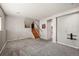 Open living room with neutral carpet, staircase, and access to laundry at 8679 Apache Plume Dr, Parker, CO 80134