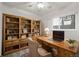 An office space with a large rustic desk and matching bookshelf at 8679 Apache Plume Dr, Parker, CO 80134