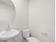 Powder room featuring white pedestal sink and toilet at 6571 N Malaya St, Aurora, CO 80019
