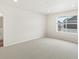 Bright bedroom with carpet, a window view and an ensuite bathroom at 6571 N Malaya St, Aurora, CO 80019