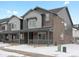 Attractive townhouse featuring a mix of brick and siding, plus covered front porches, enhancing curb appeal at 6571 N Malaya St, Aurora, CO 80019