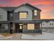 Charming two-story home with beautiful brick and siding exterior, with a cozy front porch at 6571 N Malaya St, Aurora, CO 80019