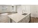 Kitchen island features a modern sink, stainless steel dishwasher, and sleek white cabinets at 6571 N Malaya St, Aurora, CO 80019