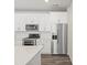 Close-up of a modern kitchen featuring stainless steel appliances and white cabinetry at 6571 N Malaya St, Aurora, CO 80019