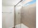 Modern shower with a glass door, tile surround, and a sleek showerhead at 6571 N Malaya St, Aurora, CO 80019