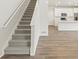 Elegant staircase with plush carpet and a bright, open floor plan to the kitchen at 6571 N Malaya St, Aurora, CO 80019